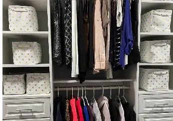 Closet shelves and hangers with shirts on them.