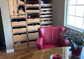 Shelves behind a desk with red chair.