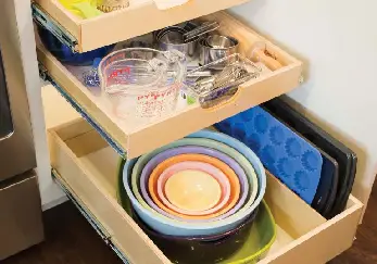 Bowls and pans in a drawer.