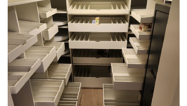 A walk-in pantry with Pull-Out shelving solutions.