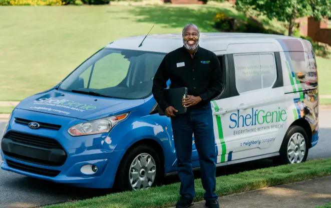 ShelfGenie team member smiling and standing by branded van.