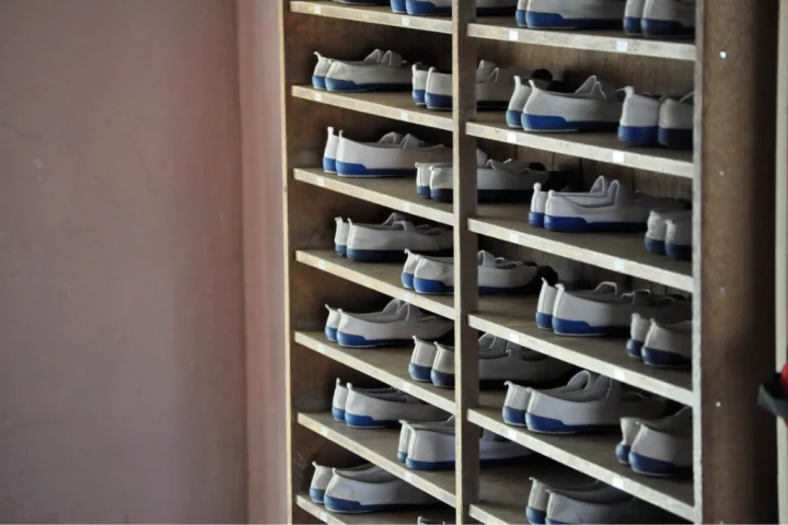 Wooden shoe cabinet with identical shoes of white and blue