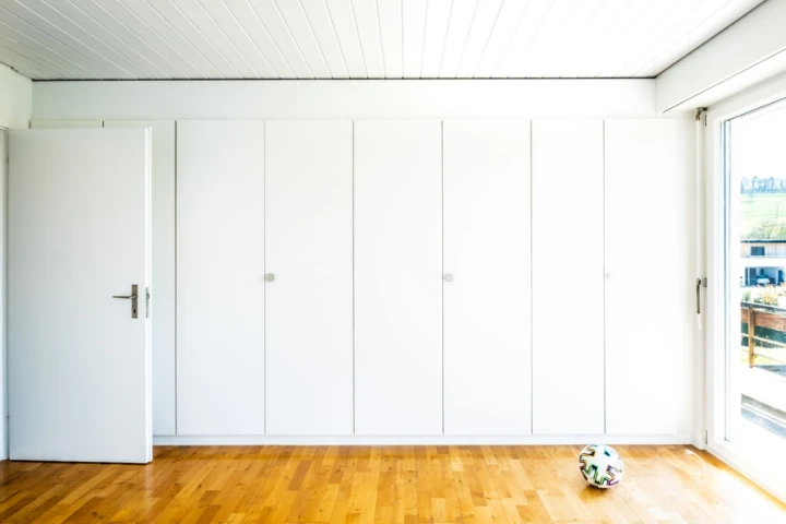 White shelves with doors and wooden floor