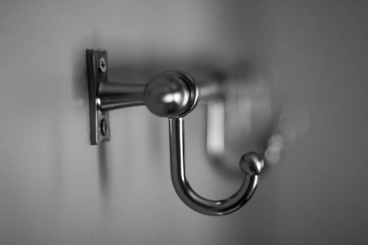 chrome storage hook hanging on a bathroom door for Small bathroom design ideas