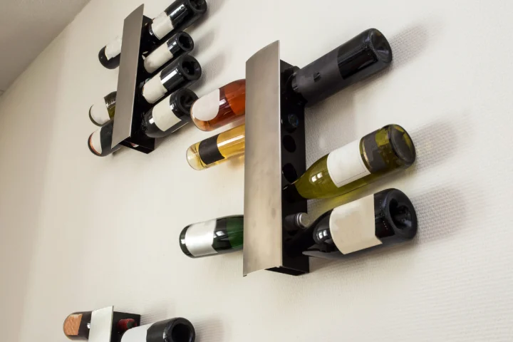 Wall-mounted wine racks keep bottles off of the counters, tables, and floors