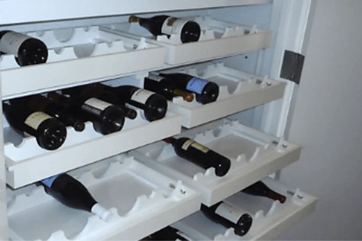Custom-made glide-out shelves for wine storage is a perfect option when the home doesn’t come with built-ins.