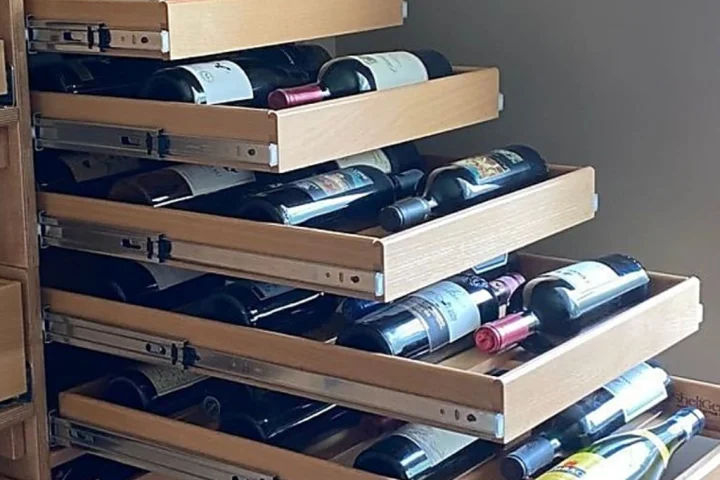 Wine bottle storage in high places is an opportunity for glide-out shelves to help you reach these items.