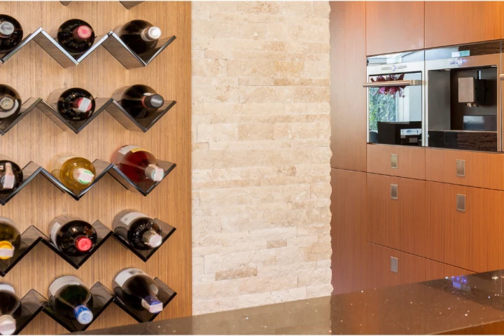 Wall mounted floated wine shelves are great for decoration as well as function.