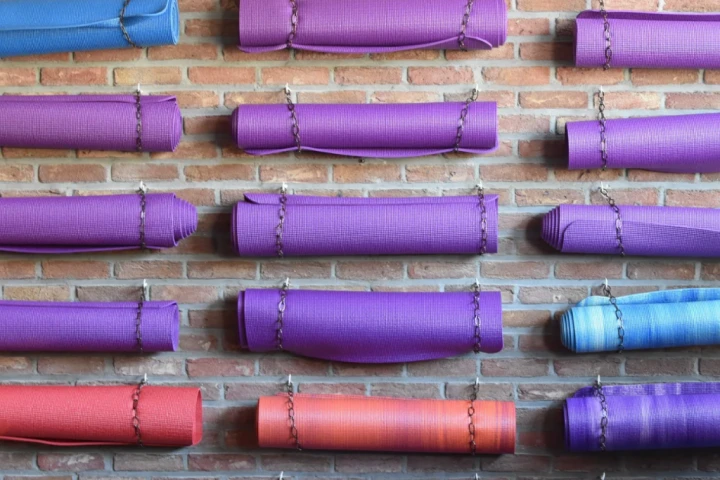 Hanging yoga and exercise mats on the wall can add some flair to your space and get the up out of the way.