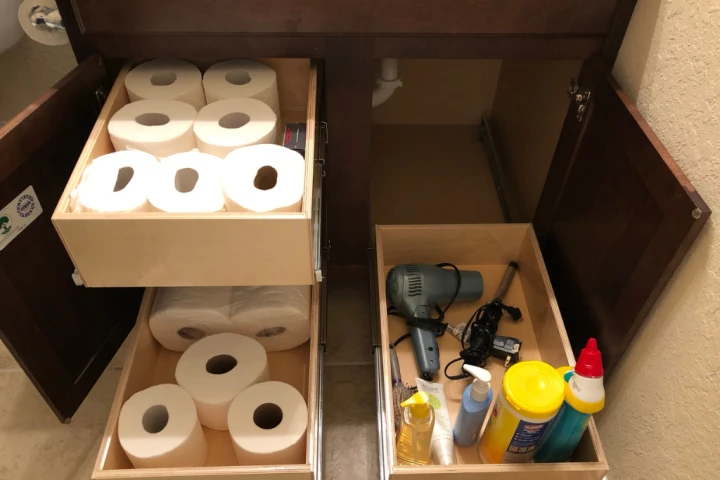 Don’t neglect the space under your sink for cleaning products and toiletry storage.