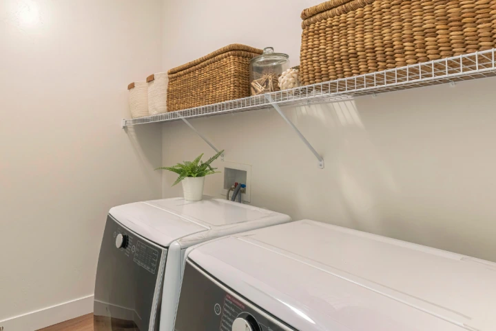 Stackable woven baskets are perfect for a variety of items to store in a utility room.