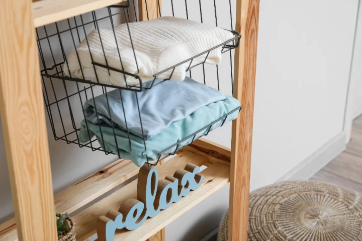 A metallic hanging organizer with multiple shelves.