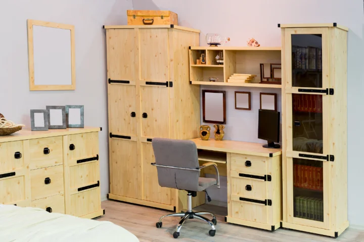Wood cabinet, dresser, shelves and desk in bedroom.