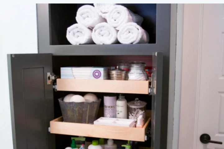 A bathroom cabinet with towels and toiletries.