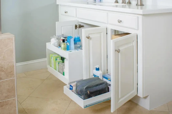 A bathroom vanity with open drawers.