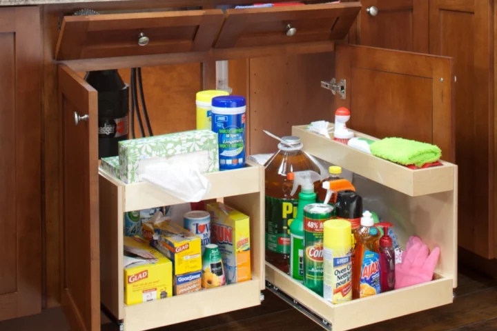 A drawer with cleaning supplies.