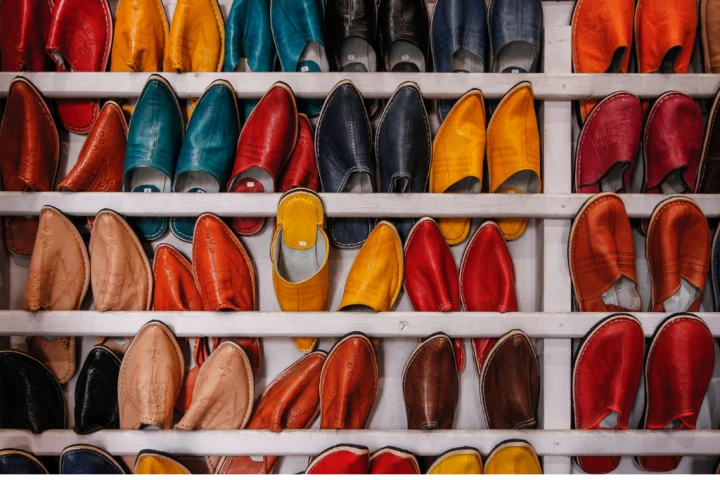 A group of colorful shoes on a shelf.