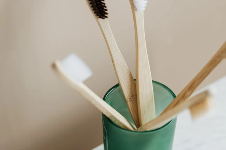 A group of toothbrushes in a glass.