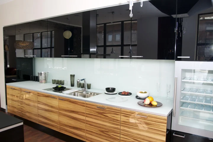 a kitchen with black cabinets and white countertops.