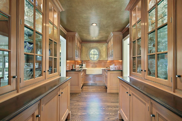 a kitchen with glass cabinets and a sink.