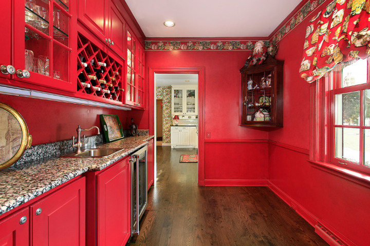 a kitchen with red cabinets and a countertop.