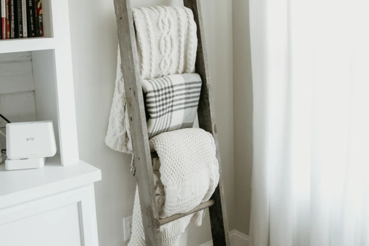 A ladder with blankets on it.webp