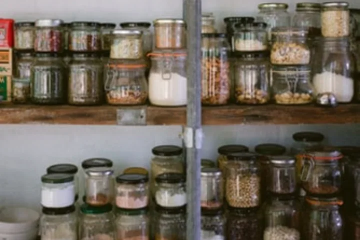 A shelf full of glass jars.