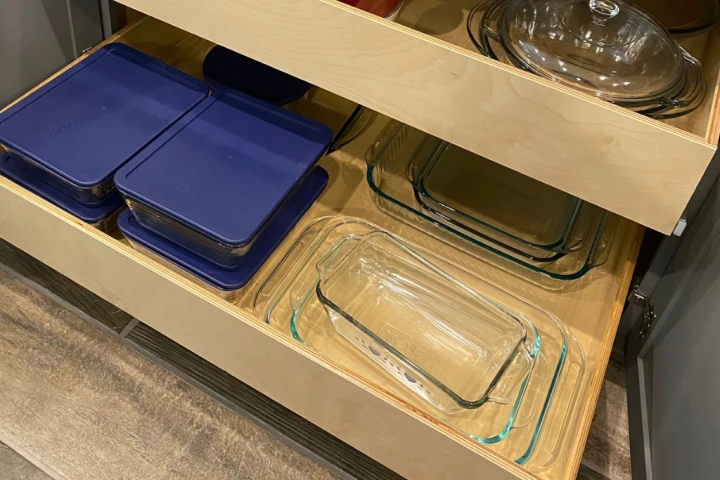 A shelf with glass containers.