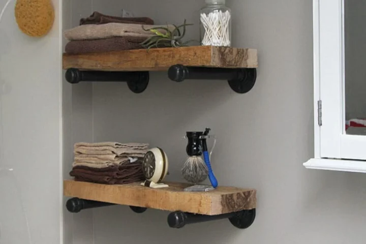 A shelf with pipes and towels.