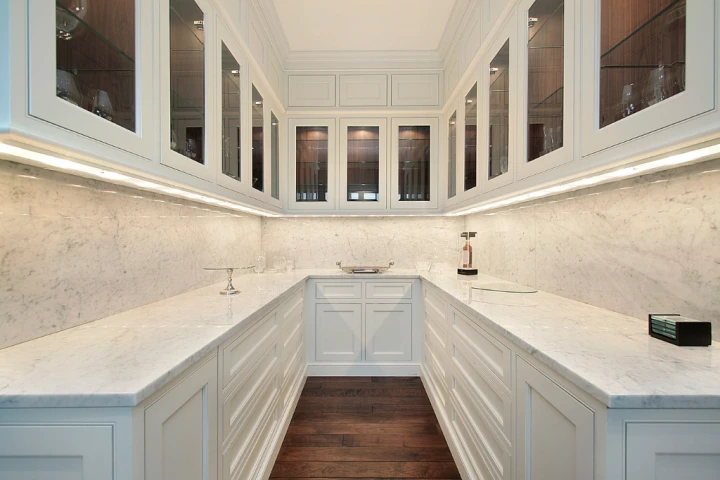 a white kitchen with glass doors.