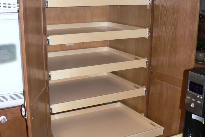 A wooden shelf in a cabinet