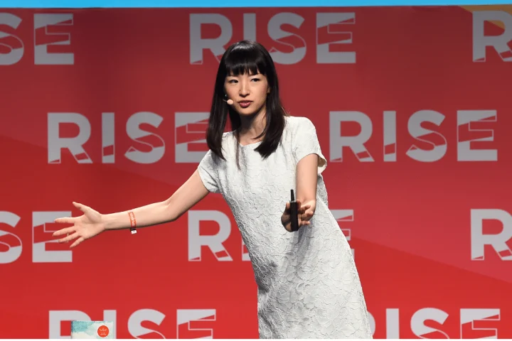 A woman speaking animatedly on stage at the rise conference