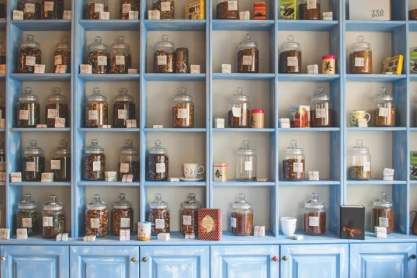 Blue pantry shelf with assorted jars.