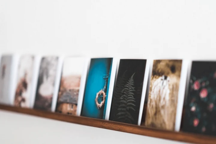 A group of pictures on a shelf.
