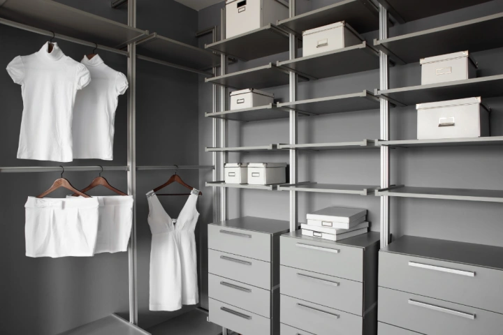 built in closet with white clothes.
