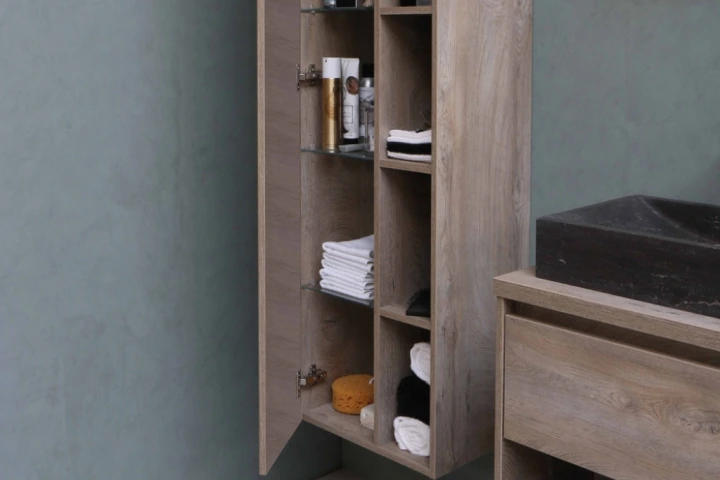 Corner cabinet with towels and other items.