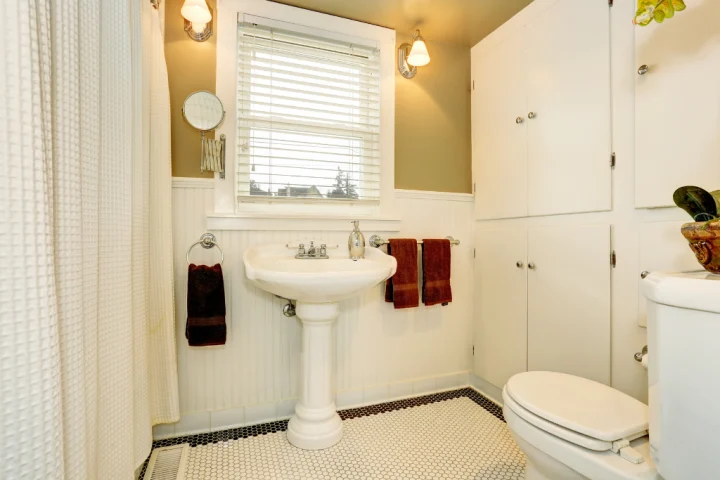 Bathroom with full-size cabinet on the wall.