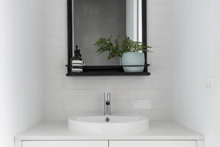 White sink and black mirror powder room idea.