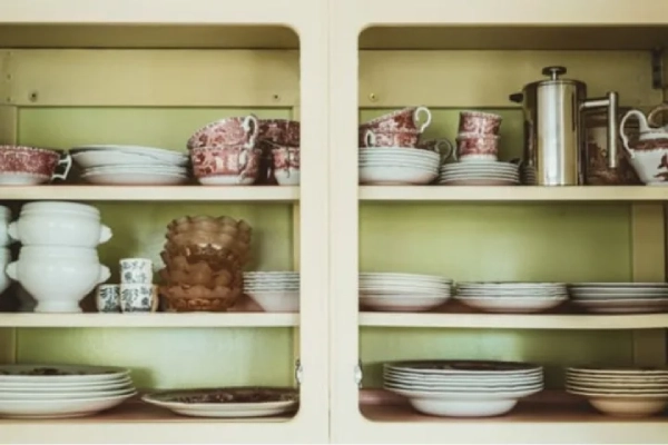Open cabinet with stack of bowls.