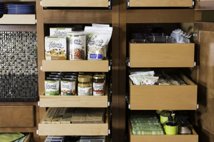 A pantry shelf with food on it.