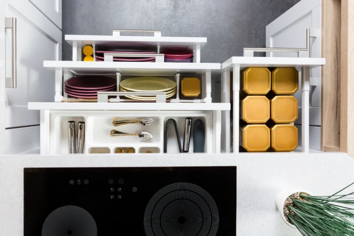 Modern kitchen drawers organized with dividers to separate utensils, cookware, and storage.