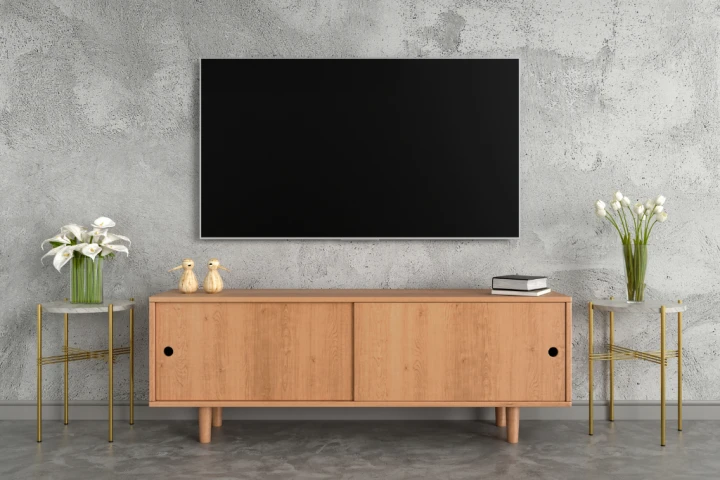 A TV stand with high legs allows you to store everyday items underneath it.