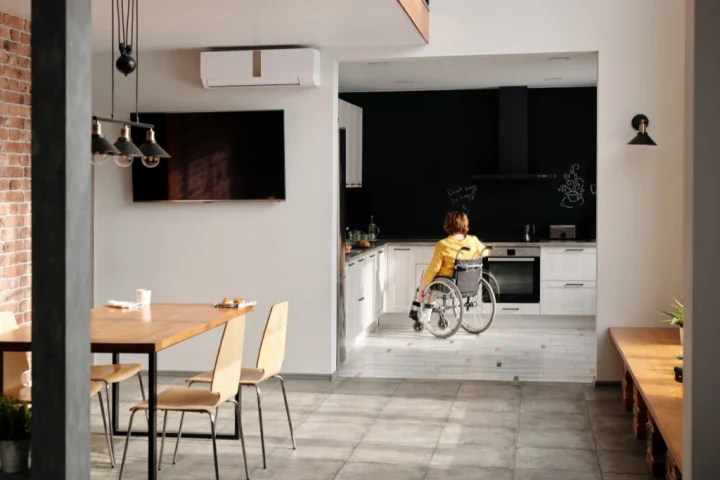 Woman in a wheelchair in the kitchen.