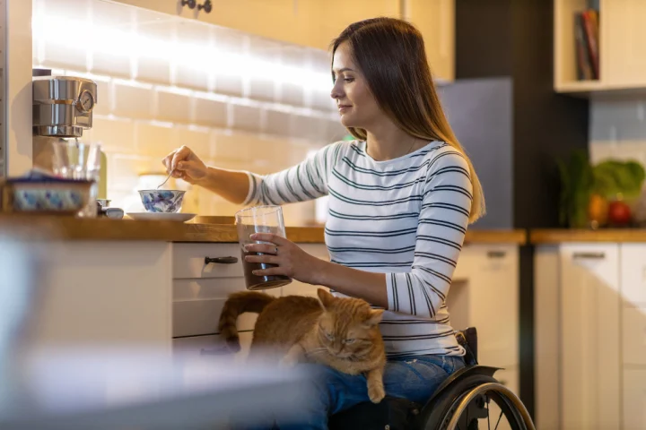 Woman in a wheelchair in the kitchen.