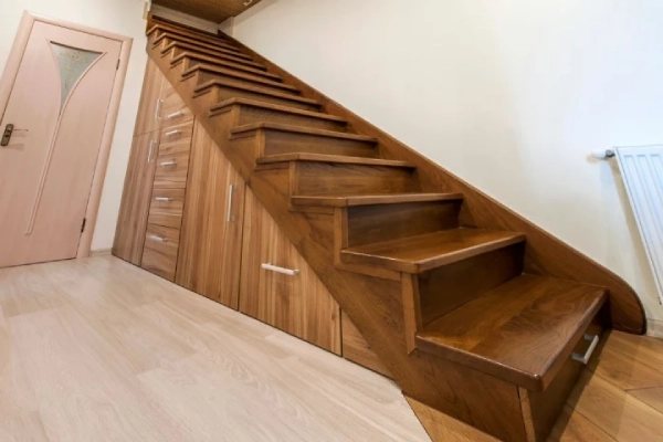 Wooden staircase with storage.
