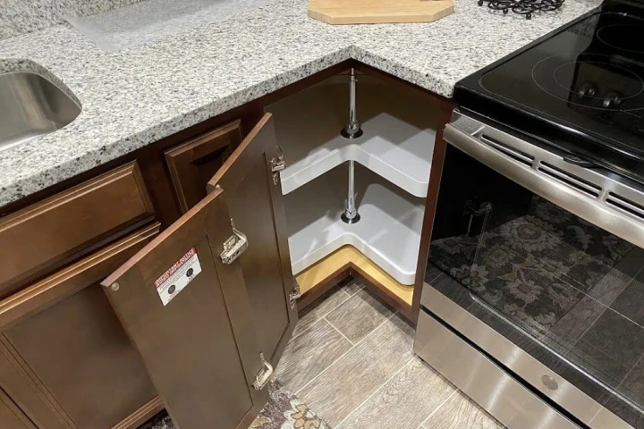 A kitchen with a corner shelf.